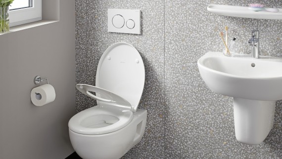 Wall-hung WC on a wall with terrazzo tiles Wall-hung WC on a wall with terrazzo tiles