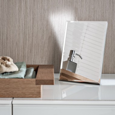 A soap dispenser reflected in a small decorative mirror A soap dispenser reflected in a small decorative mirror