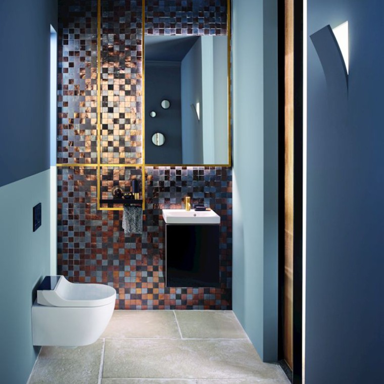 Gold and copper tones add warmth to this guest WC Gold and copper tones add warmth to this guest WC