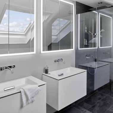 Bathroom under the roof with two washbasins and mirrors Bathroom under the roof with two washbasins and mirrors